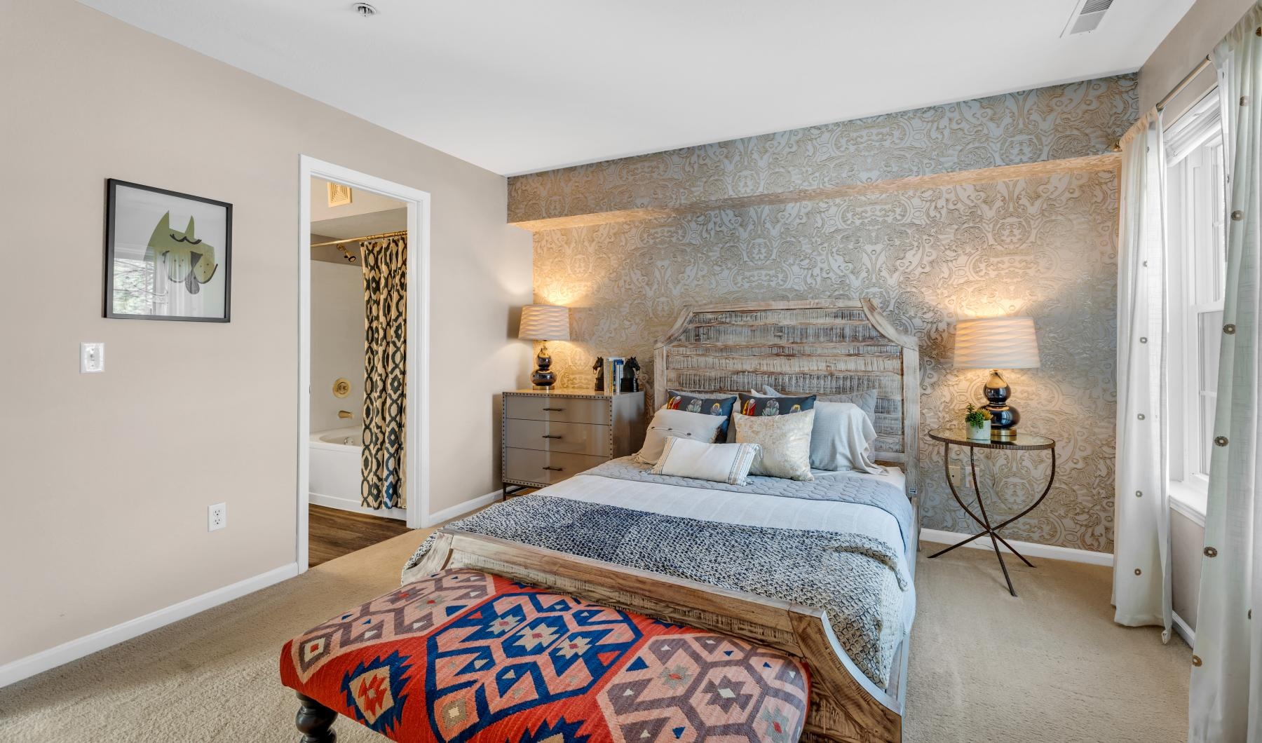 a bedroom with a bed and a lamp
