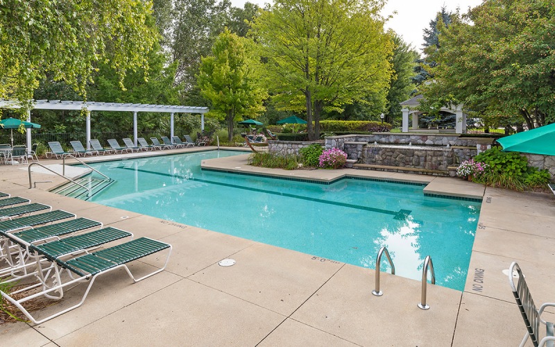 a swimming pool with chairs