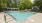 a pool with greenery in the background