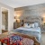 a bedroom with a bed and a lamp