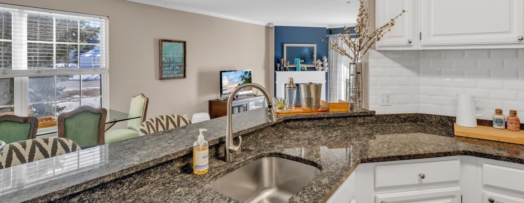 a kitchen with marble counters